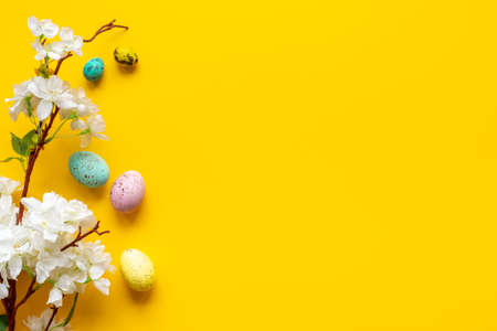 Happy Easter with eggs and flowering branch, top viewの写真素材