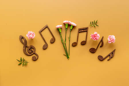 Musical wooden notes with flowers. Top view. Love songs conceptの写真素材