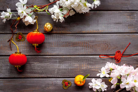 Chinese new year flat lay. Decoration with cherry flowers, red lanterns and knotsの写真素材