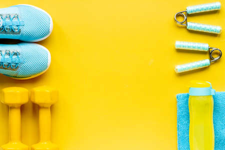 Frame of fitness gym equipment with dumbbells and sneakersの写真素材