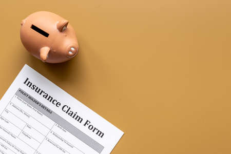 Insurance claim form with piggy bank. Top viewの写真素材