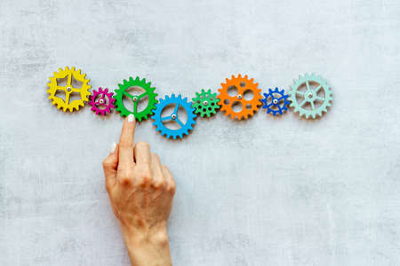 Working gears mechanism in hand. Teamwork concept. Top viewの写真素材