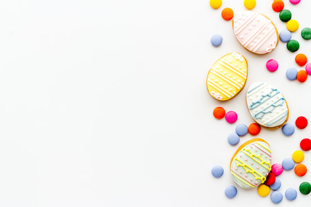 Top view of Easter cookies eggs and sweets. Space for text