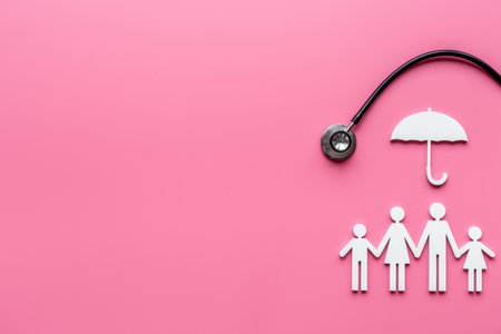 Health care and family doctor concept. Family figure with stethoscope, top viewの写真素材