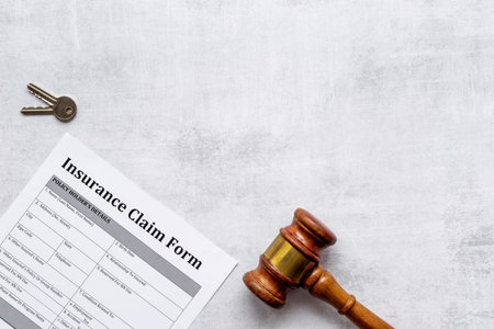 Insurance claim form with judge gavel . Top view