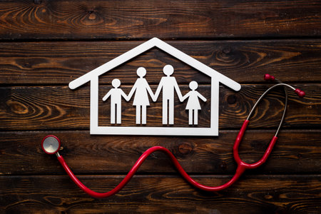 Wooden family figure with stethoscope. Life and health insurance conceptの写真素材