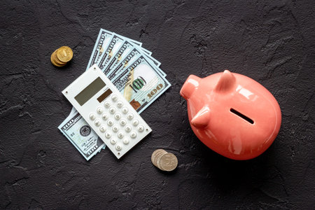 Finance and saving money concept. Piggy bank with cash money and calculator