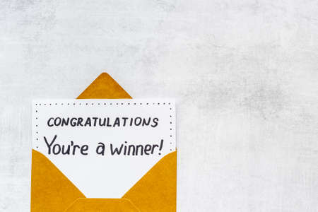 Golden envelope with award card Congratulations You are a winner. Overhead viewの写真素材
