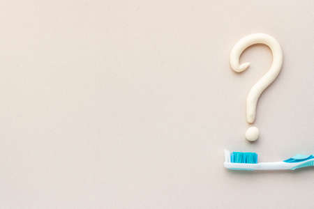 Question mark of toothpaste with toothbrush, top view. Oral care and hygieneの写真素材