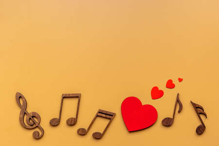 Love songs - musical wooden notes with heart, top viewの写真素材