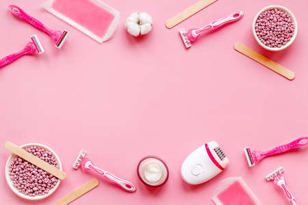 Pink epilator with wax strips and razor for removal of unwanted hair. Flat layの写真素材