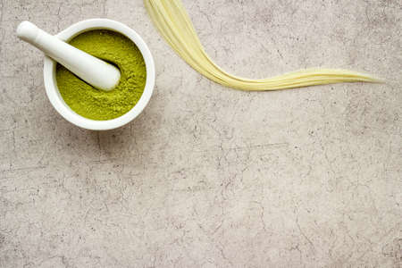 Herbal henna or mehandi powder for hair coloring or tattoo on handsの写真素材