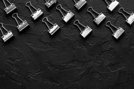 Flat lay of paper binder clips, office supplies patternの写真素材