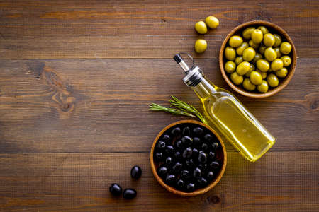 Olive oil in bottle with green and black olives, top viewの写真素材
