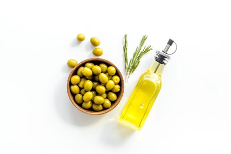 Bottle of olive oil with green raw olives, top viewの写真素材