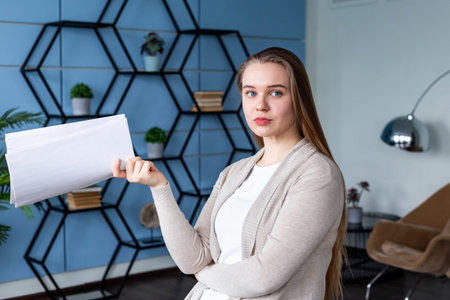Blonde woman at the office working with documentsの写真素材