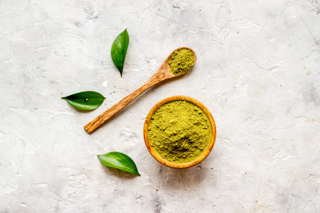 Raw matcha tea powder in wooden bowl. Natural healthy drink