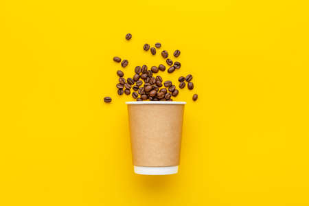 Paper coffee cup with roasted beans. Take away coffee.の写真素材