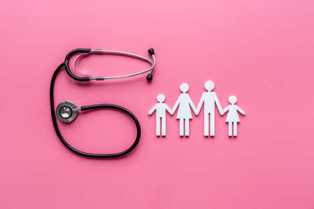 Medical care concept. Family figure with stethoscope, top viewの写真素材