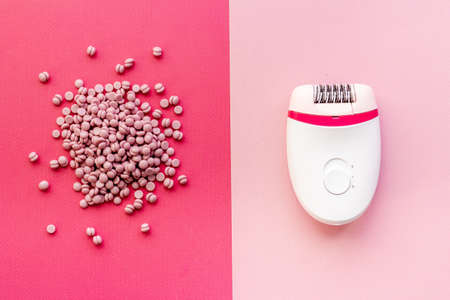 White epilator with pink wax. Epilation concept, removal of unwanted hair. Top view, flat layの写真素材