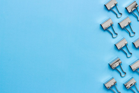 Stationery pattern, office supplies background. Paper binder clips top viewの写真素材