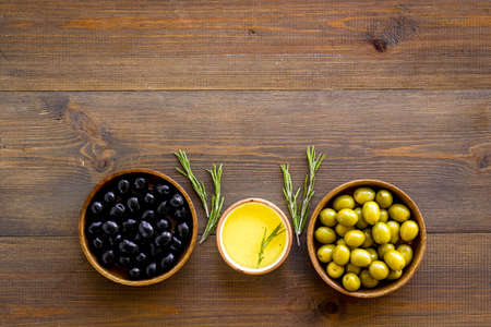 Set of green and black olives with oil in bowls. Top viewの写真素材