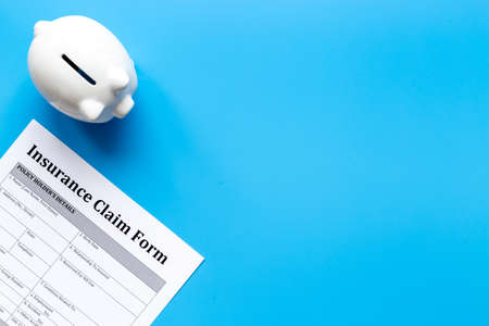 Insurance claim form with piggy bank. Top viewの写真素材