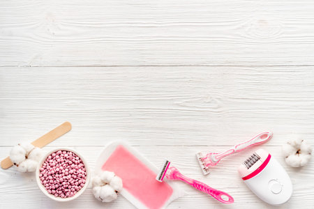 Flat lay of epilator with spa cosmetic treatments. Epilation concept