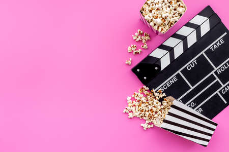 Popcorn with clapperboard and movie film reel. Cinema backgroundの写真素材