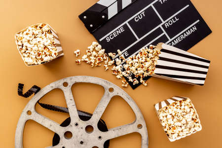 Layout of film reel with popcorn and clapperboard. Cinema conceptの写真素材