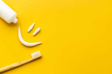 Bamboo toothbrush with toothpaste, overhead view.Dental hygiene conceptの写真素材