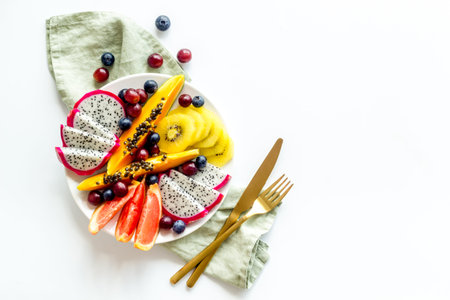 Exotic fruit dish with dragon fruit and papaya, top view