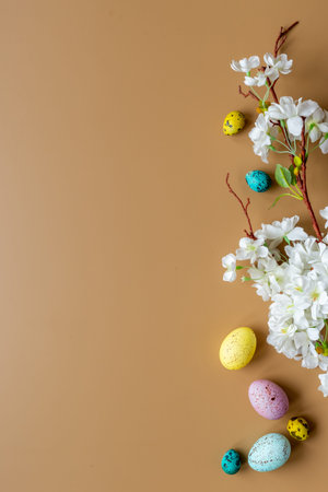 Easter eggs and spring flowers, top view