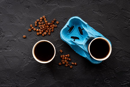 Paper coffee cups with coffee beans. Top view