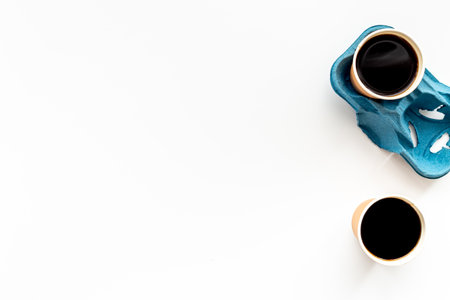 Top view of black coffee in paper cupsの写真素材