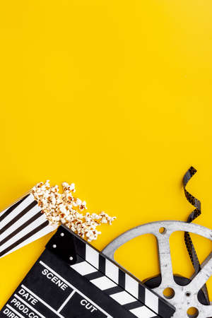 Layout of film reel with popcorn and clapperboard. Cinema conceptの写真素材