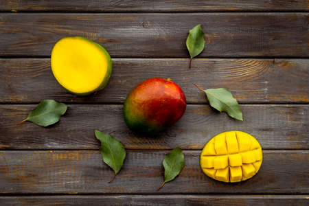 Mango fruit and mango cubes top view. Tropical fruits backgroundの写真素材