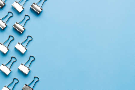 Frame of silver paper binder clips top view. Office supplies patternの写真素材