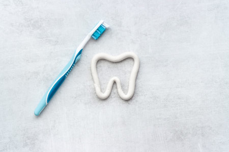 Heart shape of toothpaste with toothbrush, top view. Oral care and hygiene