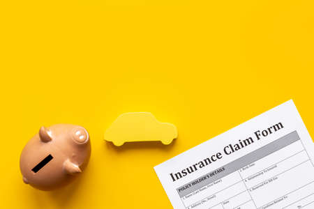 Insurance claim form with piggy bank. Top viewの写真素材