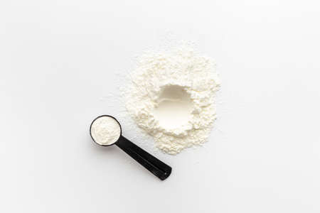 White whey protein powder in scoop. Sport nutrition conceptの写真素材