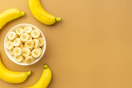 Many banana slices with whole bananas. Top viewの写真素材