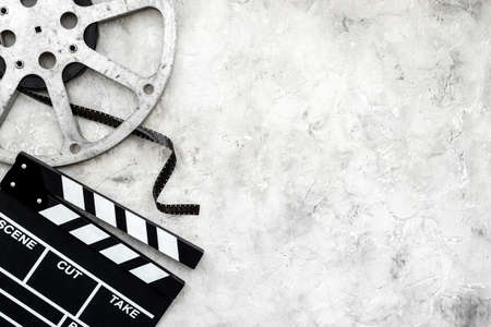 Cinema background with movie clapperboard and film reelの写真素材
