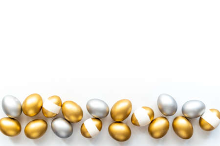 Silver and golden eggs isolated on white background. Easter decoration background. Top viewの写真素材