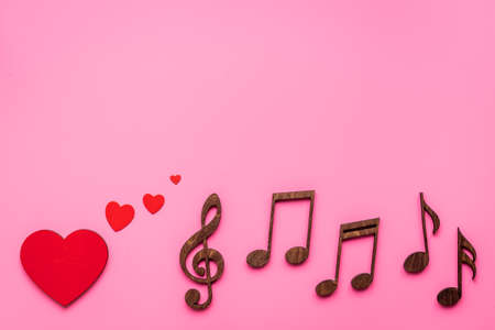 Love songs - musical wooden notes with heart, top viewの写真素材