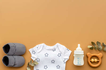 Flat lay of baby boy bodysuit with malk bottle. Baby backgroundの写真素材