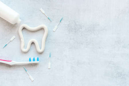 Oral care products flat lay. Toothbrushes with white tube of toothpaste and dental flossの写真素材