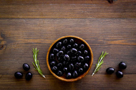 Black olives in wooden bowl. Overhead viewの写真素材