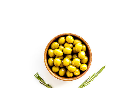 Green olives in wooden bowl. Overhead viewの写真素材