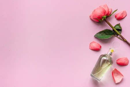 Fragrances perfume bottle with flowers, flat lay, top view